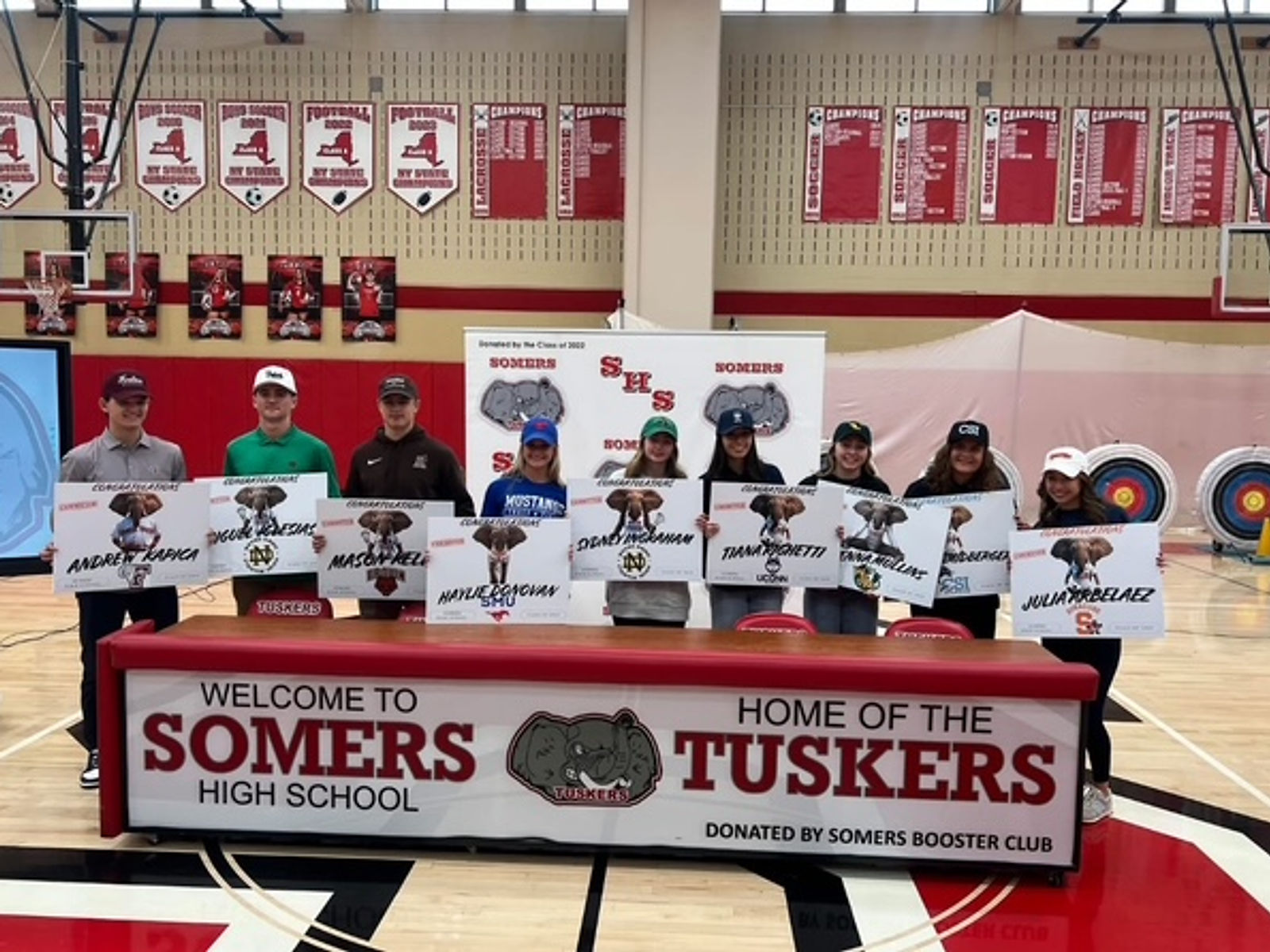 Somers student-athletes at signing day with a table donated by the Booster Club